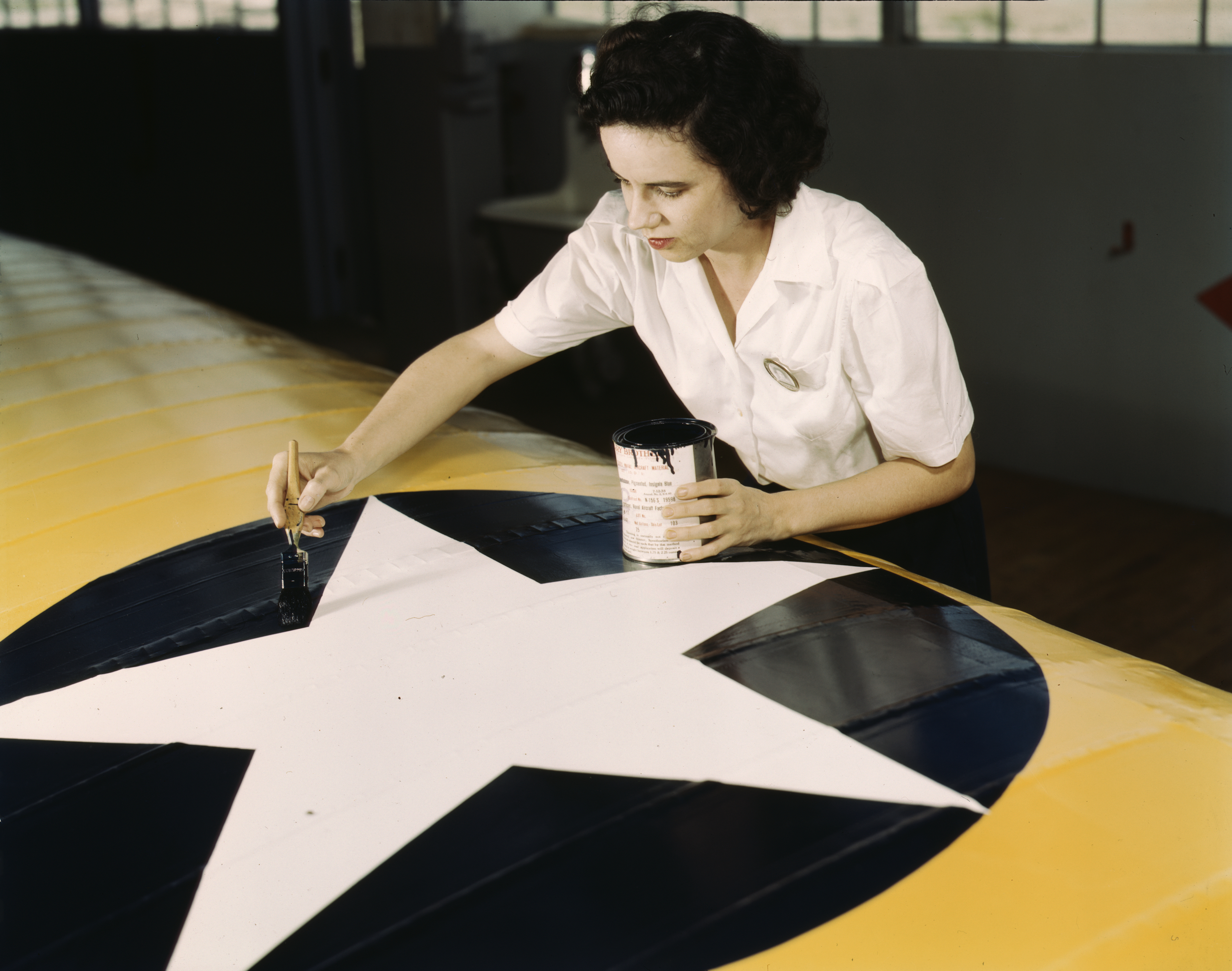 Civil Service Worker Paints Insignia on Navy Plane Wings