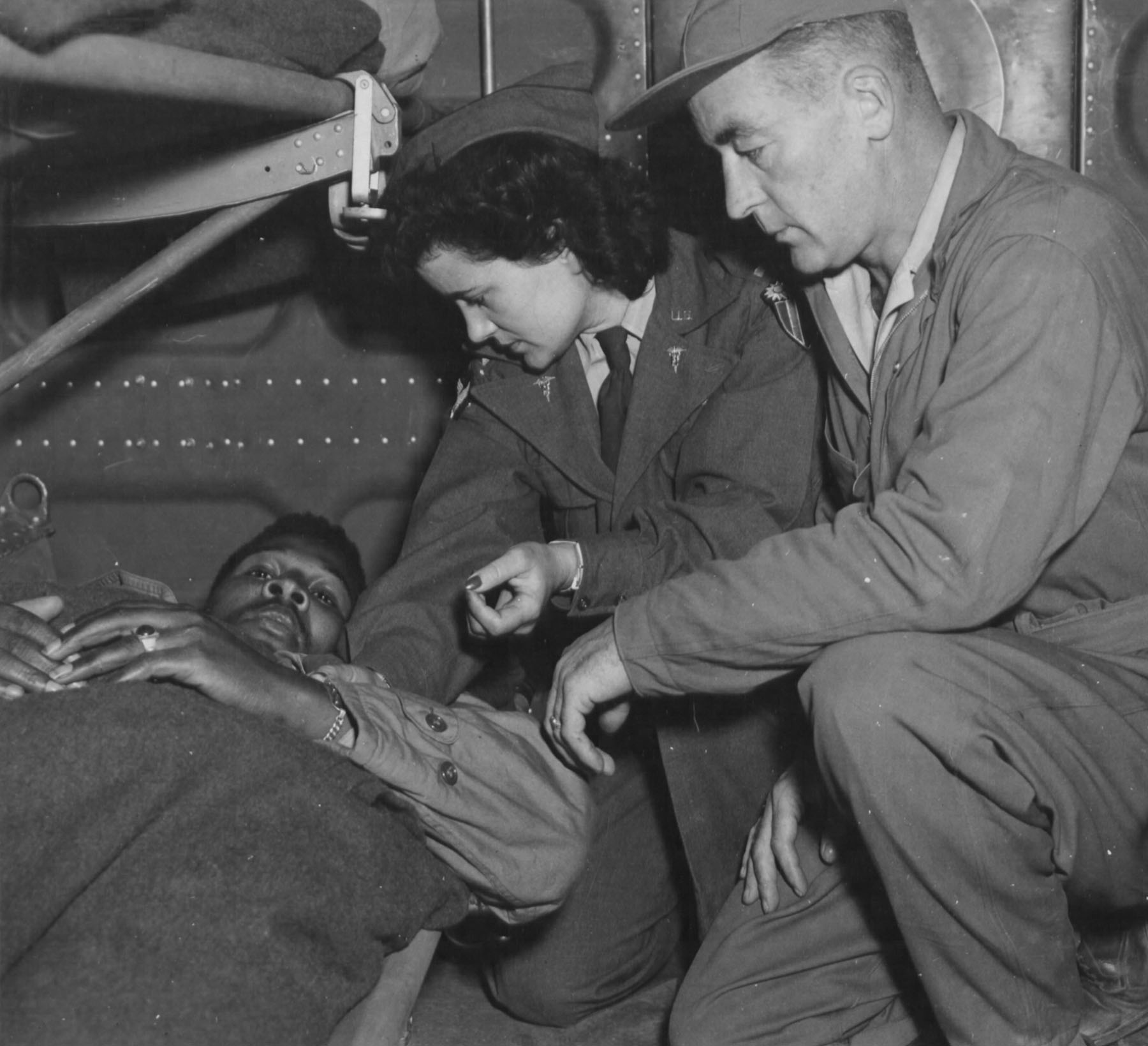 Army Flight Nurse Checks a Patient on Flight Over India