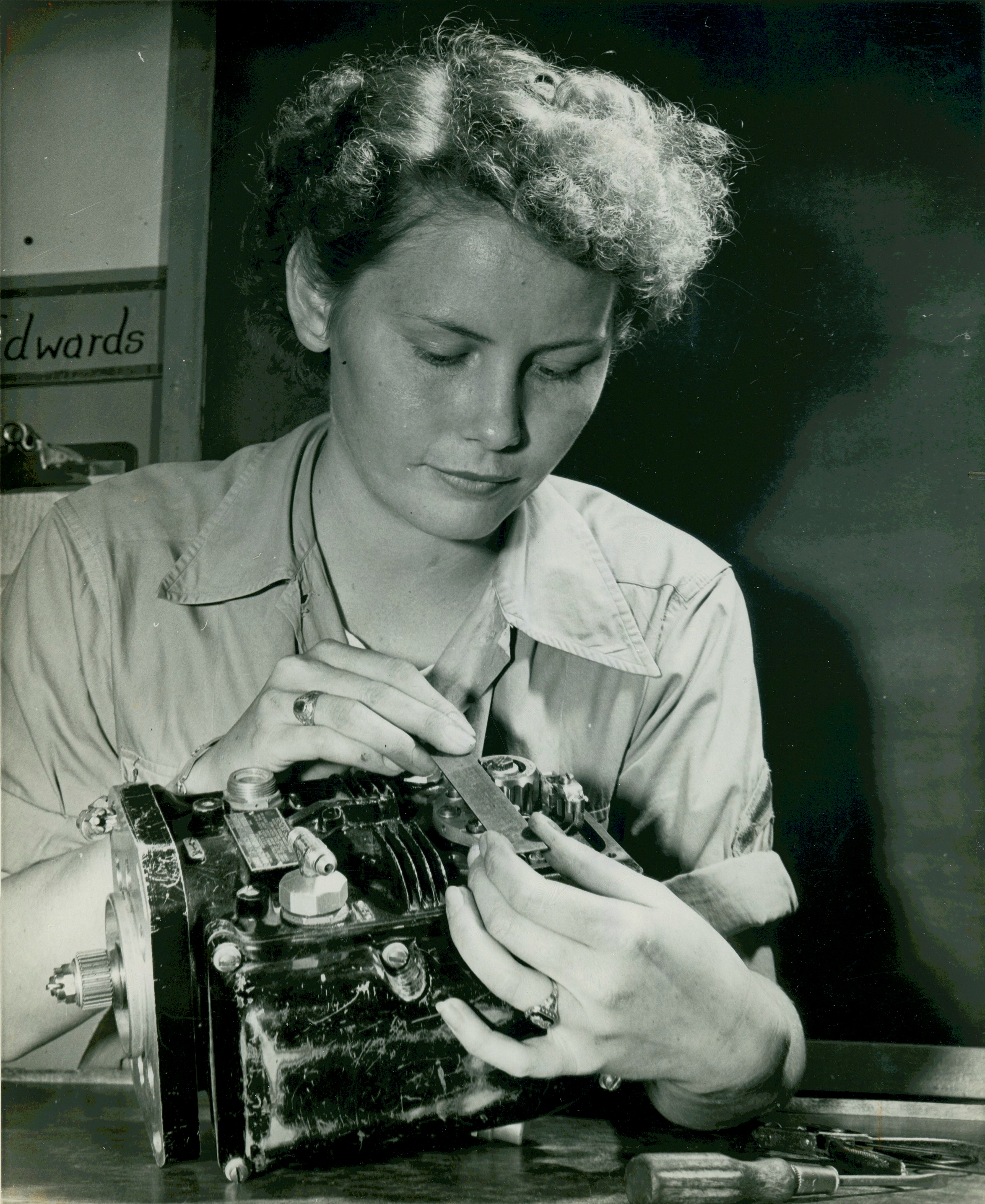 Woman Marine Works on Carburetor