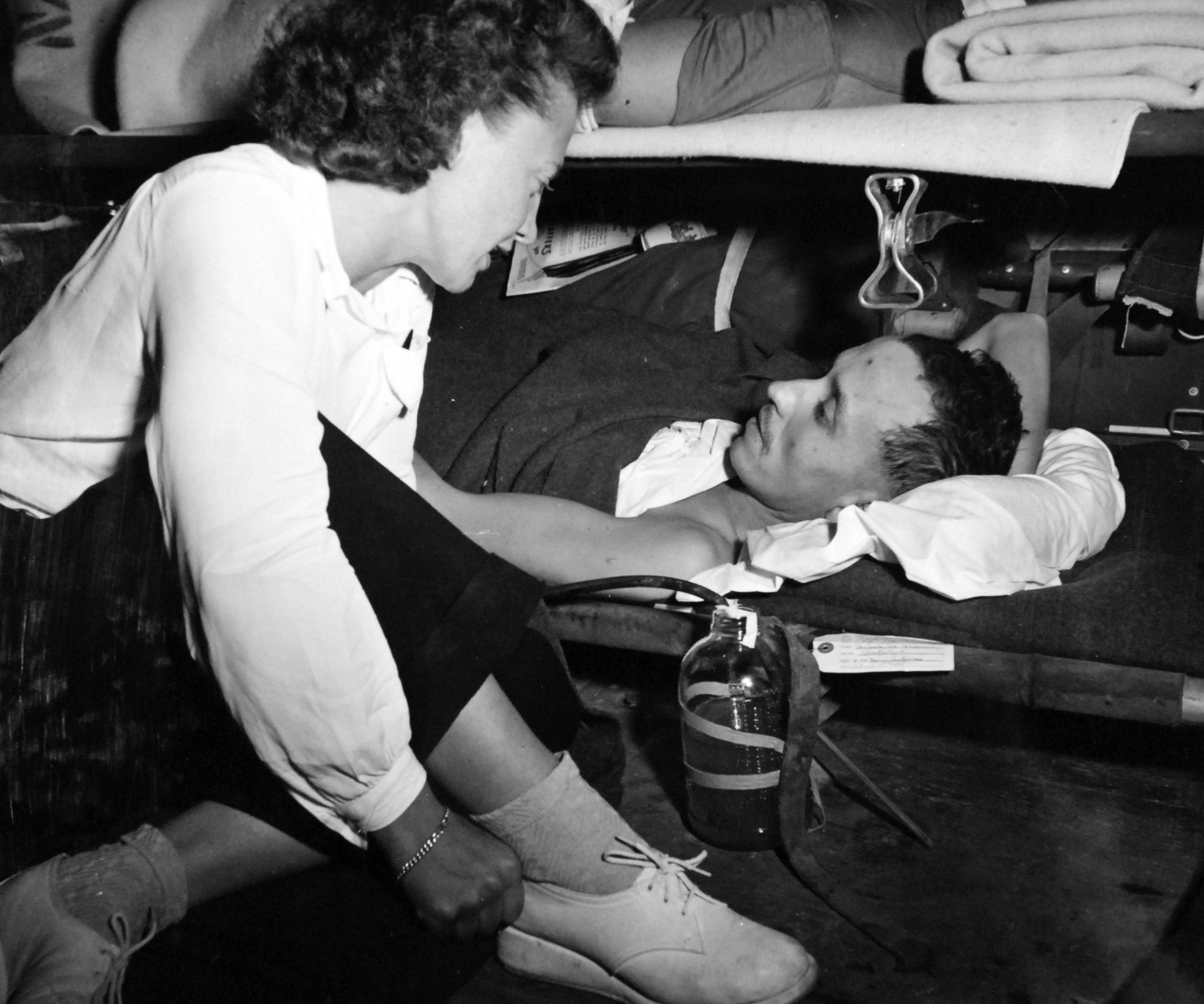 Navy Nurse Comforts Patient During Air Evacuation