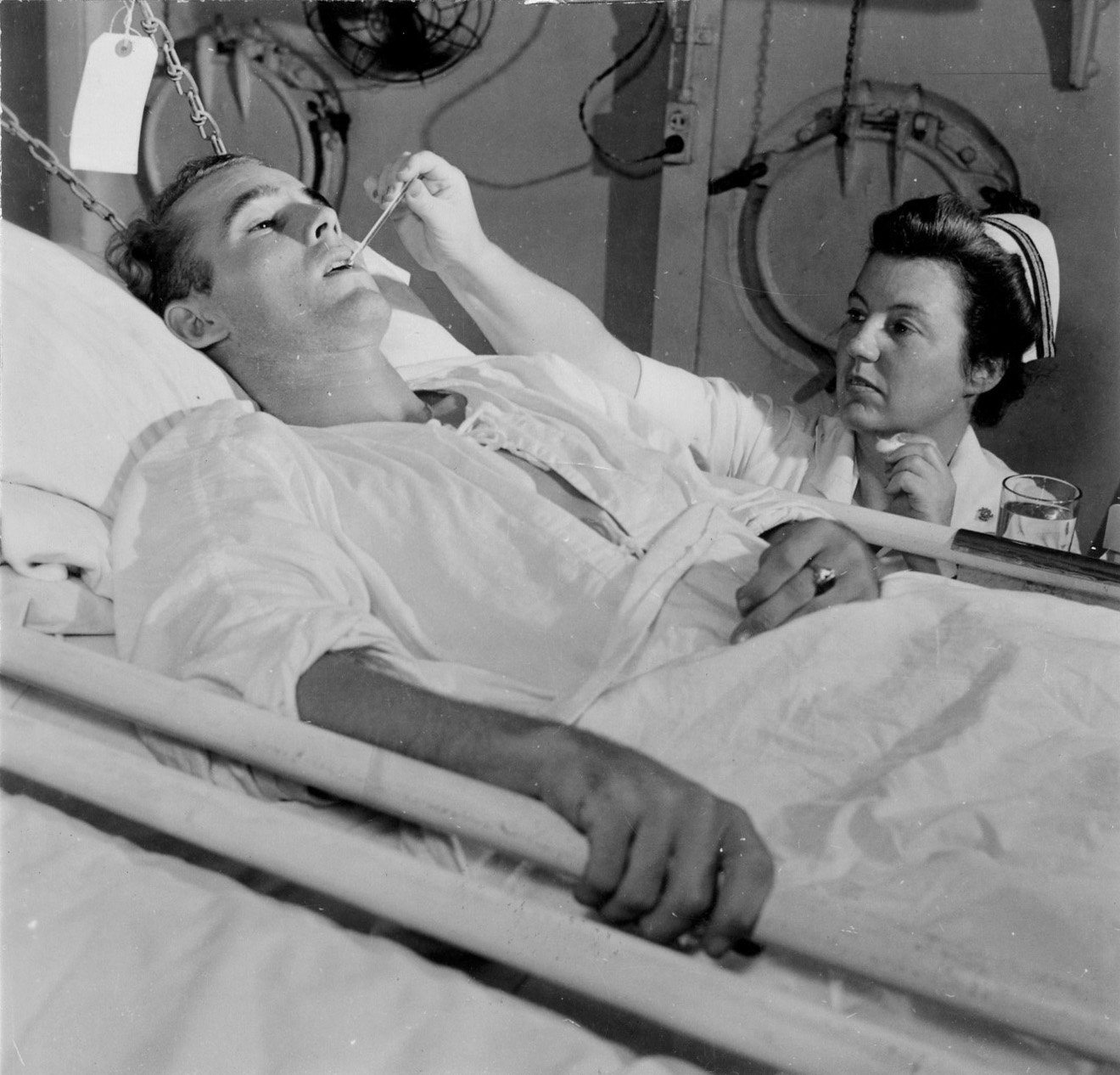 Navy Nurse Takes Patient's Temperature on Hospital Ship